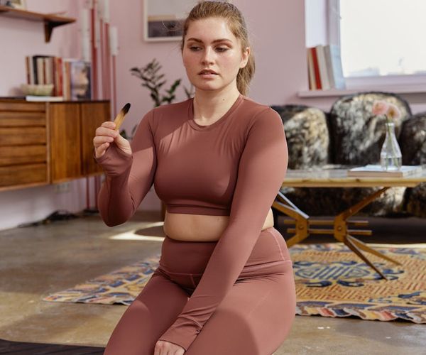 A cozy corner of a room with a yoga mat, suggesting a daily routine.